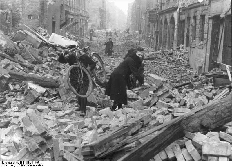 Berliners stumble through the rubble of the city following an Allied air attack - February 1945