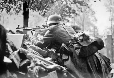 German soldiers in a defensive position on Kolonnenstrasse in Berlin. The man in the foreground is armed with an StG 44 assault rifle with a ZF-4 scope.