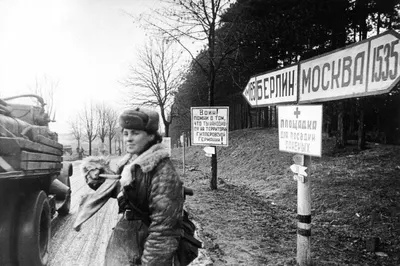 A female Soviet soldier directing traffic 165km from Berlin