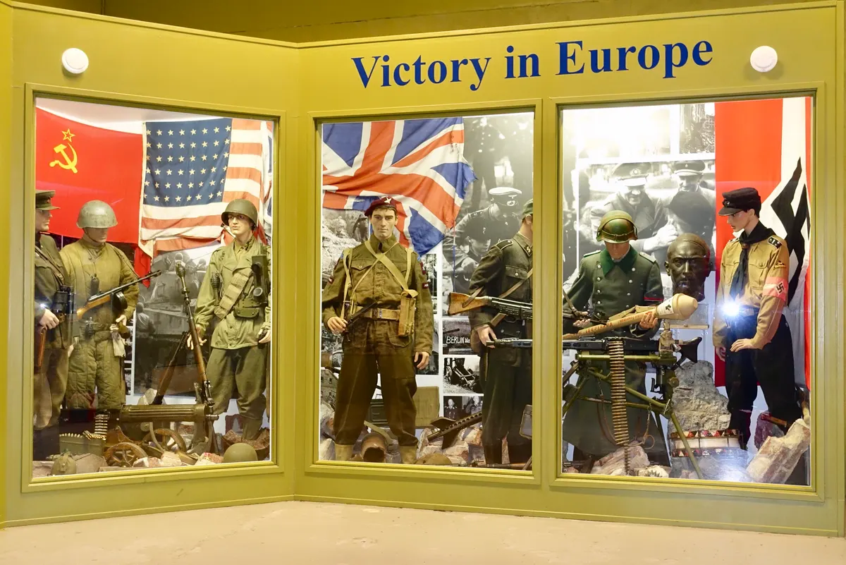 Arquebus Krigshistorisk Museum Norway. WW2 Allied Victory in Europe display. Uniforms weapons equipment USSR Red Army officer private US private British paratrooper battle dress German Waffen-SS Volkssturm Hitlerjugend flags photos A