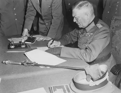 Field Marshall Wilhelm Keitel, signing the ratified surrender terms for the German Army at Russian Headquarters in... - NARA - 531290